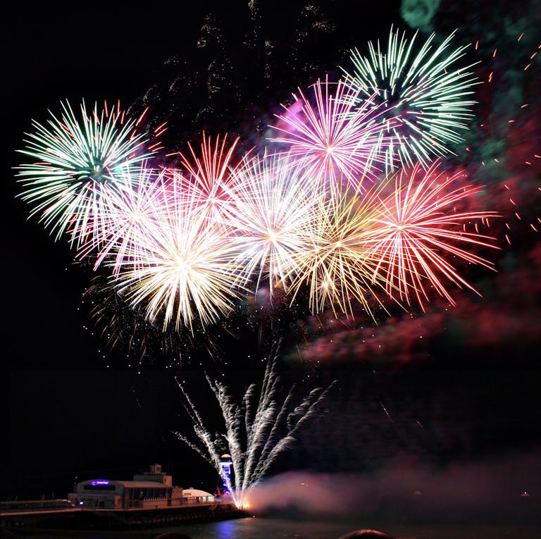 Spectacular fireworks display lighting up the night sky over Bournemouth Pier, England.